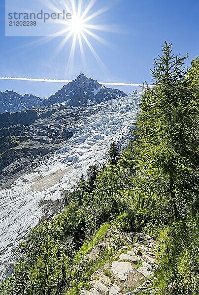 View of glacier Glacier des Bossons with sun star  behind summit of Aiguille du Midi  Chamonix  Haute-Savoie  France  Europe