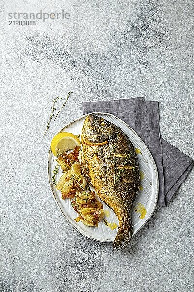 Food  Food  Grilled sea bream or dorada on gray plate. Gray background