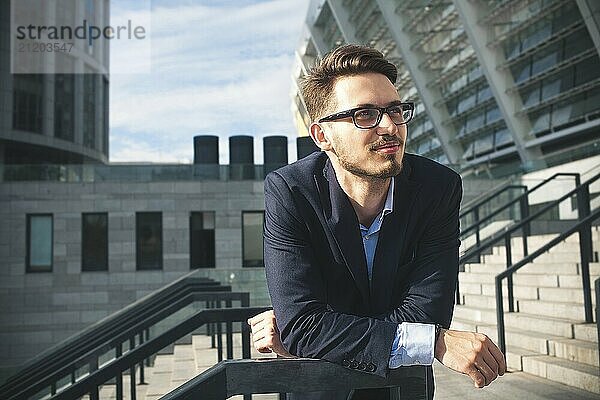 Happy businessman stand on stairs and dreaming about something