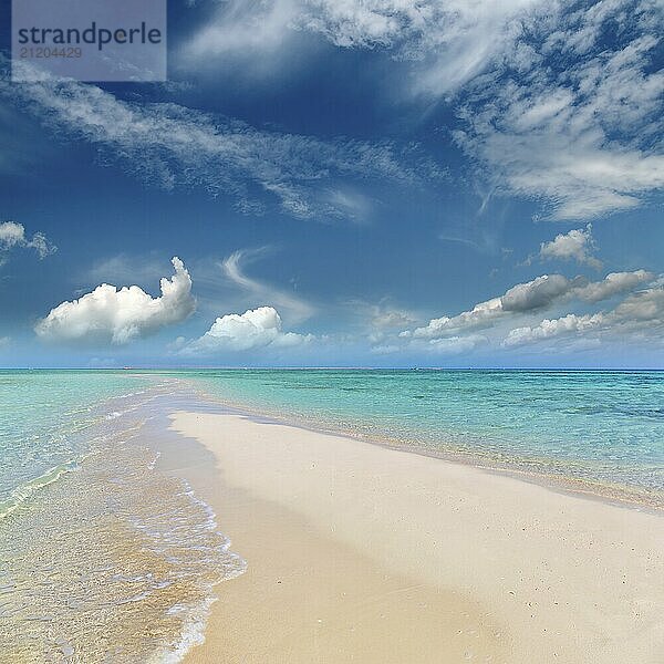 Beautiful landscape with white sandy sea spit beach leading into a warm tropical ocean