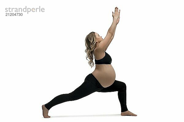 Young pregnant woman in black sportswear doing fitness isolated profile shot