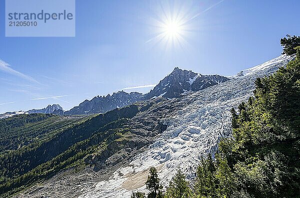 View of glacier Glacier des Bossons with sun star  behind summit of Aiguille du Midi  Chamonix  Haute-Savoie  France  Europe