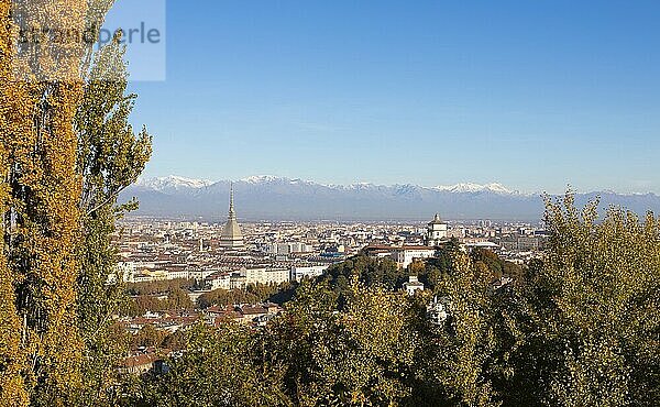 Turin  Italy  Circa November 2021: panorama with Alps and Mole Antonelliana  . Skyline of the symbol of Piedmont Region withi Monte dei Cappuccini  Cappuccini's Hill. Sunrise light  Autumn  Europe