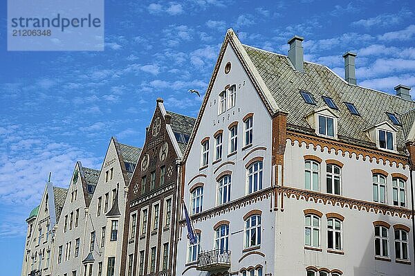 Row of historic Hanseatic houses with striking facades under a clear blue sky  Bryggen  Bergen  Vestland  Norway  Europe