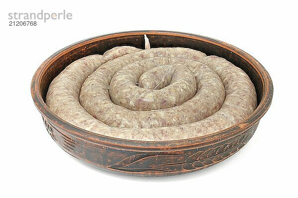 Homemade sausage for baking  raw in a clay dish isolated on a white background