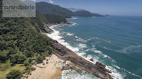 Aerial view to wonderful Green Coast shoreline with rock slabs  beach and mountains covered with Atlantic Forest  Picinguaba  Brazil  South America