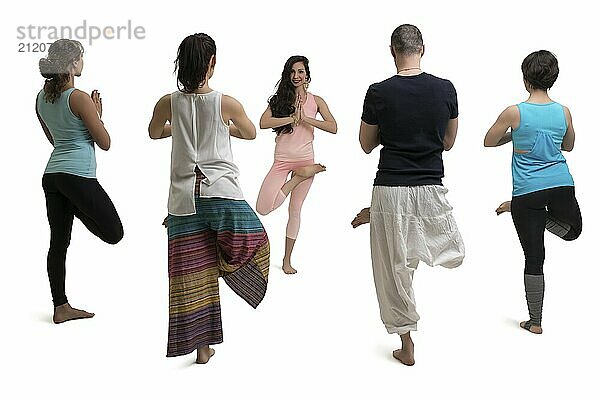 Group of women and their male trainer in sportswear doing yoga view isolated on white