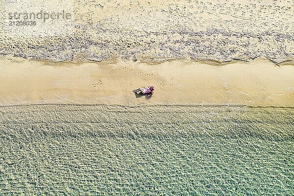 A beautiful woman at the beach Mandraki of Skiathos from drone view  Greece  Europe