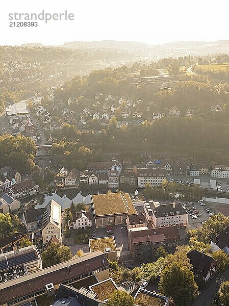 Bird's eye view of a hilly town at sunset  with typical houses and streets surrounded by green vegetation and rolling hills  Calw  Black Forest  Germany  Europe