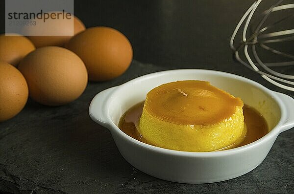 Traditional Brazilian dessert  milk pudding on dark background