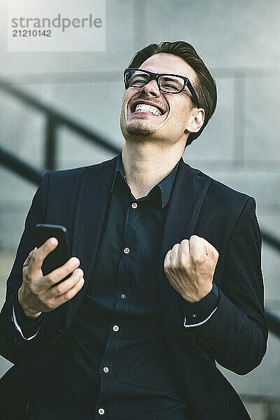 Happy caucasian businessman in glasses dressed at classic wear standing at the street