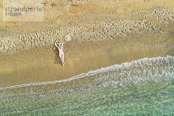 A beautiful woman at the beach Agia Eleni of Skiathos from drone view  Greece  Europe