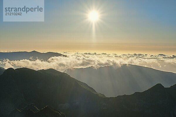 Aerial drone view of mountains over clouds near Pico Ruivo on sunset. Madeira island  Portugal  Europe