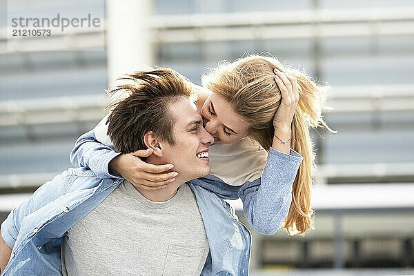 Happy to spending time together. Young beautiful couple outdoor fashion portrait. Attractive boy and girl hugging and kissing