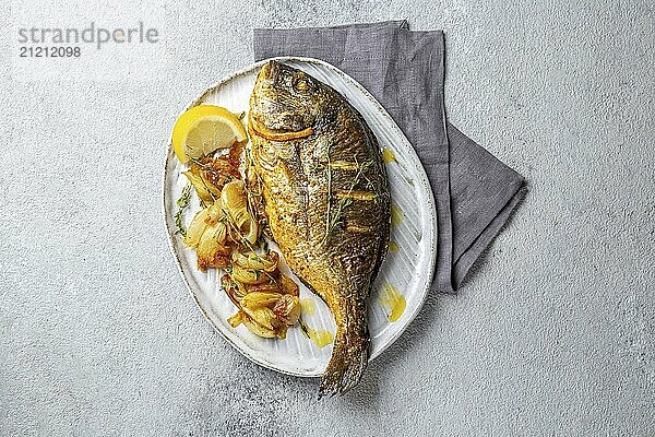 Food  Food  Grilled sea bream or dorada on gray plate. Gray background