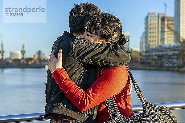 LGBT couple of women embracing each other on a bridge  enjoying a moment of connection