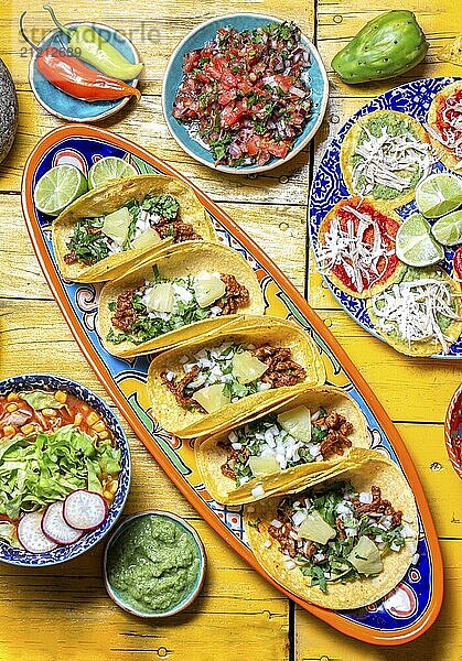 Food  Food  Mexican festive food for independence day  independencia chiles en nogada  tacos al pastor  chalupas pozole  tamales  chicken with mole poblano sauce. Yellow background