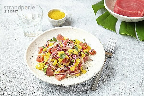 Food  Food  Tropical Hawaiian tahitian tuna mango salad on white plate on tropical monstera leafe