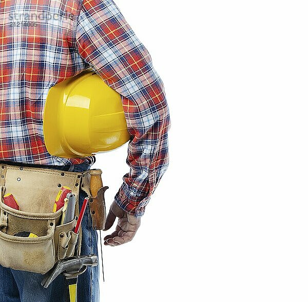 Middle aged caucasian contractor with tool belt holds yellow hard hat under his hand on white background