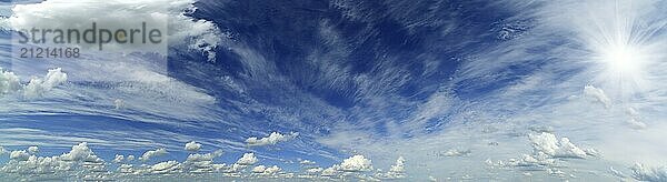 Wide panorama of beautiful sky with clouds and sun