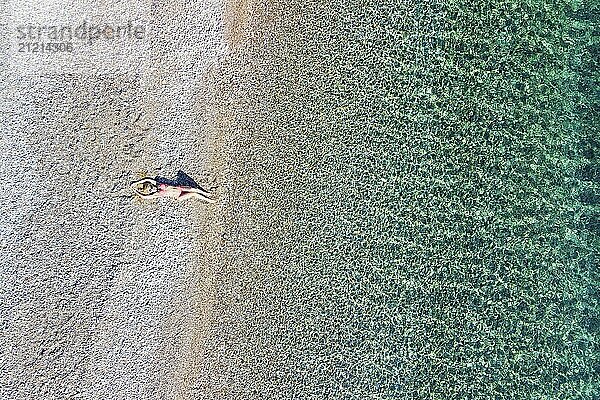 A beautiful woman at the beach Agios Dimitrios of Alonissos island from drone view  Greece  Europe