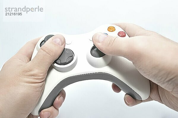 Joystick gamepad in the player's hands isolated on white background