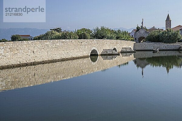 Skyline of a small Mediterranean town  historic city centre with massive city walls on an island in a bay or lagoon. Morning atmosphere in Nin  Zadar  Dalmatia  Croatia  Adriatic Sea  Europe