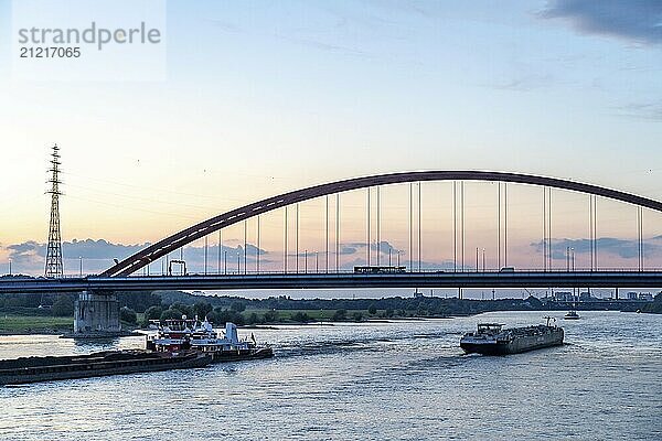 The Bridge of Solidarity  the longest tied-arch bridge in Germany  over the Rhine from Duisburg-Hochfeld to DU-Rheinhausen  the road bridge is dilapidated and has to be rebuilt  many thousands of lorries from the Logport port and cars use the bridge every day  new construction by 2040  cargo ships  Duisburg  North Rhine-Westphalia  Germany  Europe