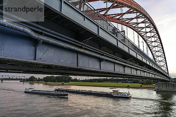 The Bridge of Solidarity  the longest tied-arch bridge in Germany  over the Rhine from Duisburg-Hochfeld to DU-Rheinhausen  the road bridge is dilapidated and has to be rebuilt  many thousands of lorries from the Logport port and cars use the bridge every day  new construction by 2040  cargo ships  behind the Duisburg-Hochfeld railway bridge  Duisburg  North Rhine-Westphalia  Germany  Europe