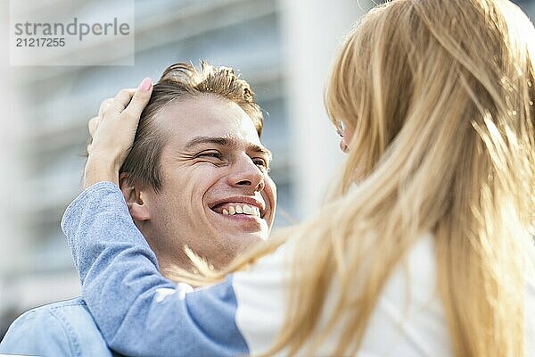 Happy to spending time together. Young beautiful couple outdoor fashion portrait. Attractive boy and girl hugging and kissing