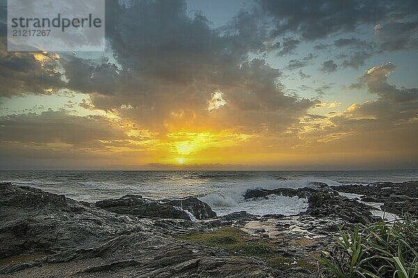 Strand  mit Lavafelsen und Vegetation  Blick auf das Meer am Abend bei Sonnenuntergang. Landschaft mit Wolken in Induruwa  Bentota Beach  Sri Lanka  Indien  Asien