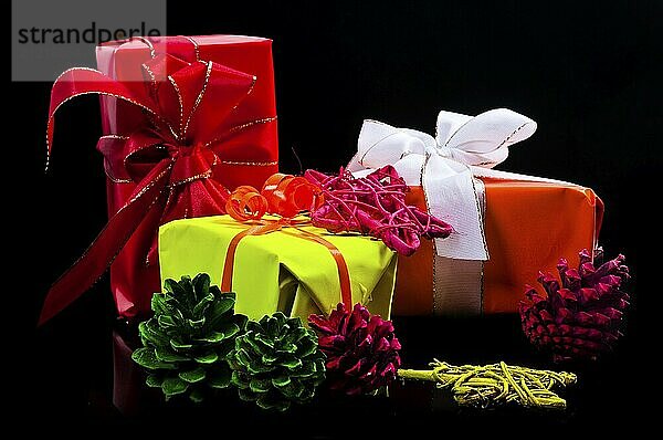 Presents  Christmas baubles and stars in neon colours on a black background