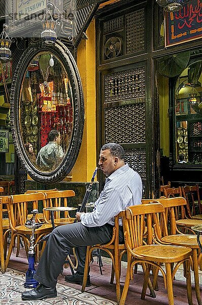 Business man man smoking in cairo cafe in egypt