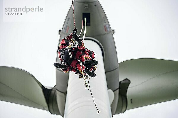 Height rescuers from the Gelsenkirchen fire brigade practise abseiling from a wind turbine from a height of 110 metres after rescuing an accident victim from the nacelle  Gladbeck  North Rhine-Westphalia  Germany  Europe