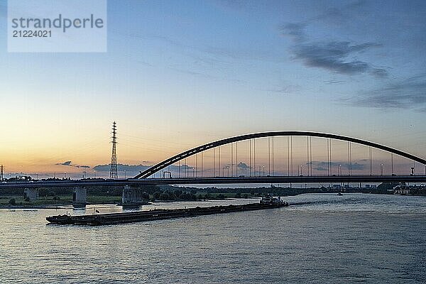 The Bridge of Solidarity  the longest tied-arch bridge in Germany  over the Rhine from Duisburg-Hochfeld to DU-Rheinhausen  the road bridge is dilapidated and has to be rebuilt  many thousands of lorries from the Logport port and cars use the bridge every day  new construction by 2040  cargo ships  Duisburg  North Rhine-Westphalia  Germany  Europe