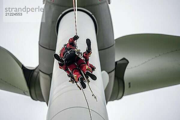 Height rescuers from the Gelsenkirchen fire brigade practise abseiling from a wind turbine from a height of 110 metres after rescuing an accident victim from the nacelle  Gladbeck  North Rhine-Westphalia  Germany  Europe