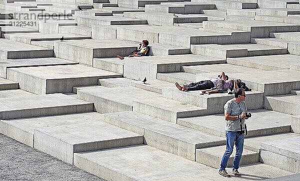 Funchal  madeira  portugal  13 march 2019: a man taking pictures and people sunbathing on the geometric concrete area of the park next to the marina in funchal madeira