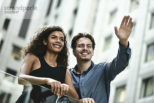 Happy international couple have a conversation in city. Mixed-race woman and caucasian man