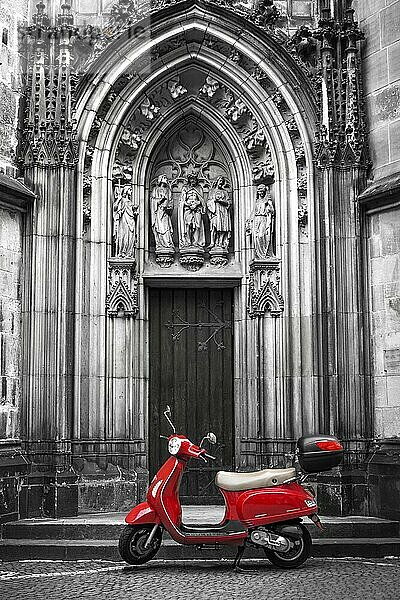 Red scooter in front of the Lambertikirche in Münster  North Rhine-Westphalia (Nordrhein-Westfalen)