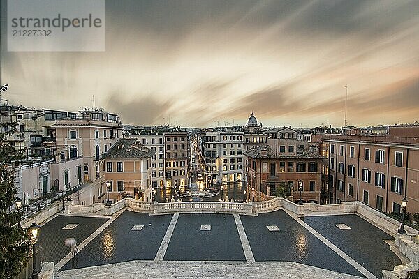 View over a beautiful historic Roman city. At one of the sights  with old buildings and urban flair. Morning sunrise at the Spanish Steps Scalinata di Trinità dei Monti  Rome  Italy  Europe