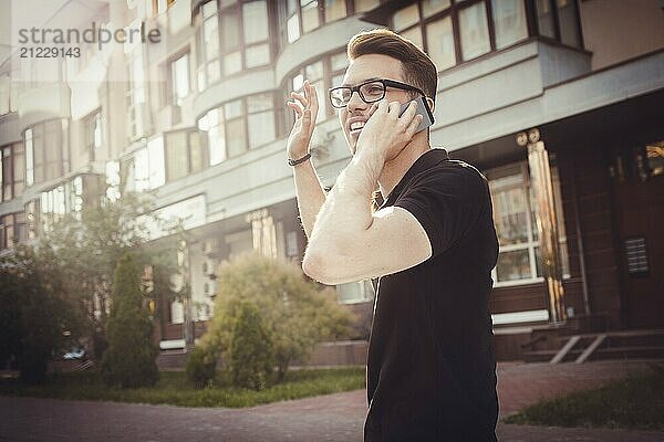 Cheerful young man waving his hand to say hello