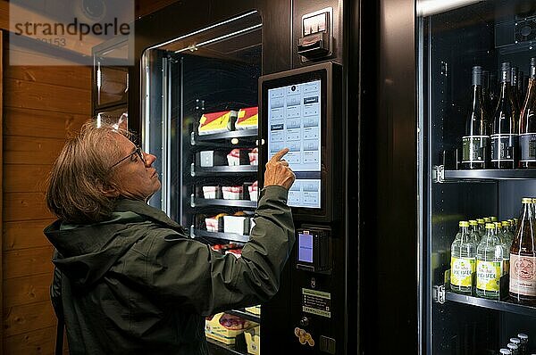 Elderly woman buying groceries at vending machine  display  food vending machine  farm shop  Stuttgart  Baden-Württemberg  Germany  Europe