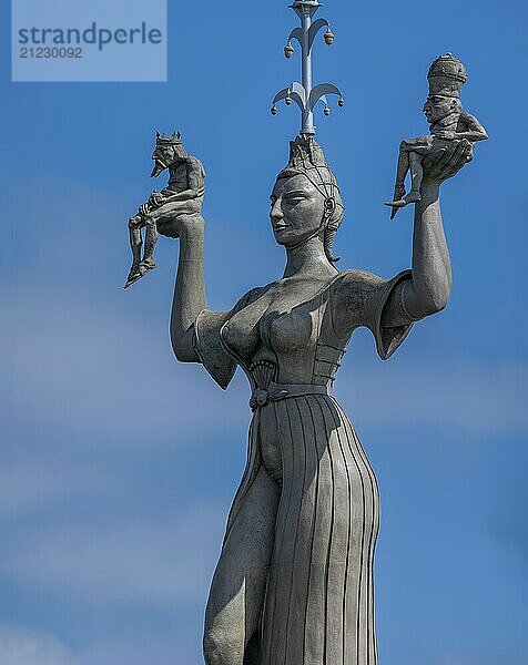 Imperia  a rotating  nine-metre-high concrete statue in the port of Constance  designed by Peter Link. The statue is a satirical reminder of the Council of Constance (1414-1418) . On her raised hands  the Imperia carries two small naked men  in her right hand a king with crown and orb  in her left hand a man with a papal tiara and crossed legs  Constance  Baden-Württemberg  Germany  Europe