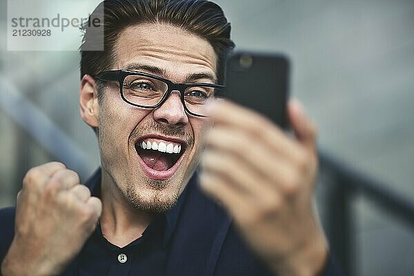 Happy caucasian businessman in glasses dressed at classic wear standing at the street