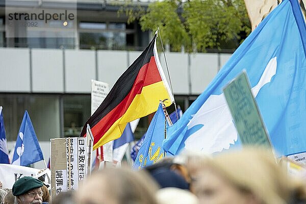 A German flag between peace flags at the Die Waffen nieder demonstration on Breitscheidplatz in Berlin. The event is directed against all wars and calls for an immediate stop to all arms deliveries. Berlin  03.10.2024