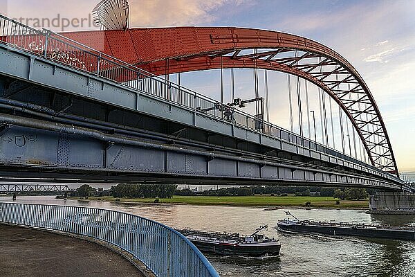 The Bridge of Solidarity  the longest tied-arch bridge in Germany  over the Rhine from Duisburg-Hochfeld to DU-Rheinhausen  the road bridge is dilapidated and has to be rebuilt  many thousands of lorries from the Logport port and cars use the bridge every day  new construction by 2040  cargo ships  behind the Duisburg-Hochfeld railway bridge  Duisburg  North Rhine-Westphalia  Germany  Europe