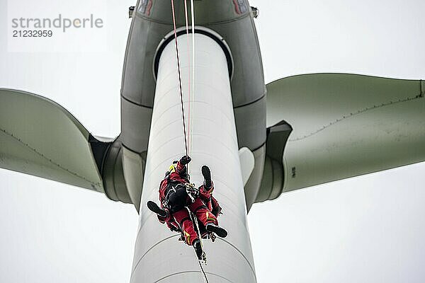 Height rescuers from the Gelsenkirchen fire brigade practise abseiling from a wind turbine from a height of 110 metres after rescuing an accident victim from the nacelle  Gladbeck  North Rhine-Westphalia  Germany  Europe