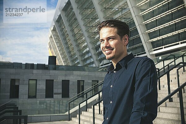 Happy businessman stand on stairs and dreaming about something