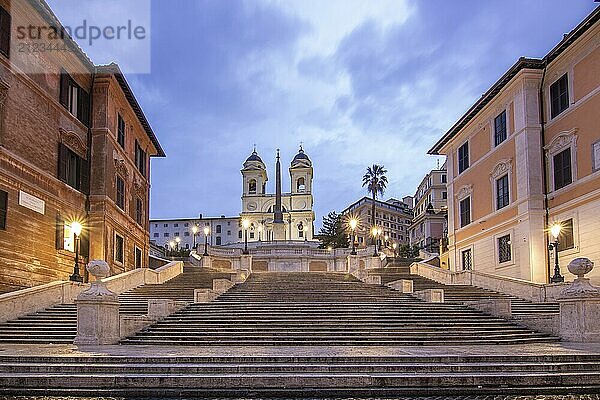 View over a beautiful historic Roman city. At one of the sights  with old buildings and urban flair. Morning sunrise at the Spanish Steps Scalinata di Trinità dei Monti  Rome  Italy  Europe