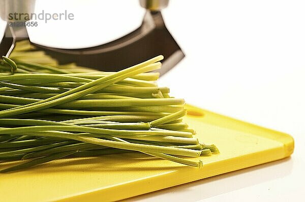 Chives on a yellow board with a white background